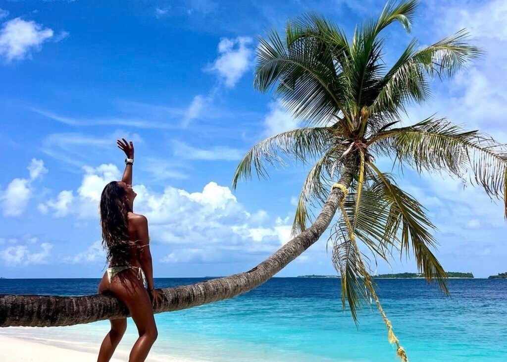 subida al tronco de una palmera torcida en una isla local de las islas Maldivas